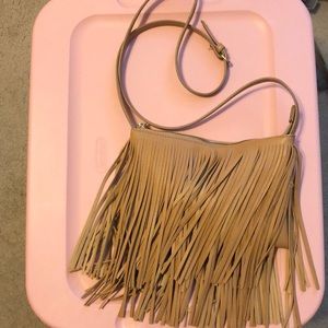 Crossbody tan tassel purse.